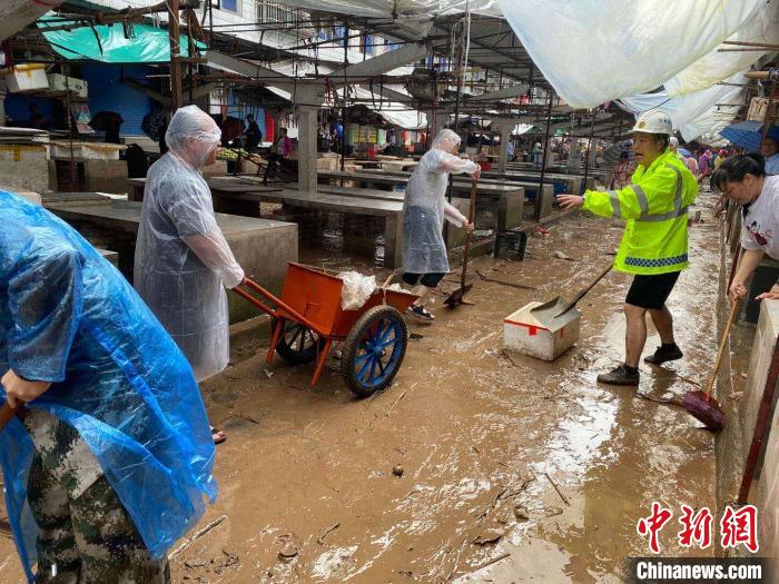 圖為7月26日，暴雨引發(fā)的洪水過(guò)境后，重慶萬(wàn)州區(qū)分水鎮(zhèn)政府干部職工及志愿者清掃淤泥和垃圾?！　≈貞c萬(wàn)州區(qū)委宣傳部供圖 攝